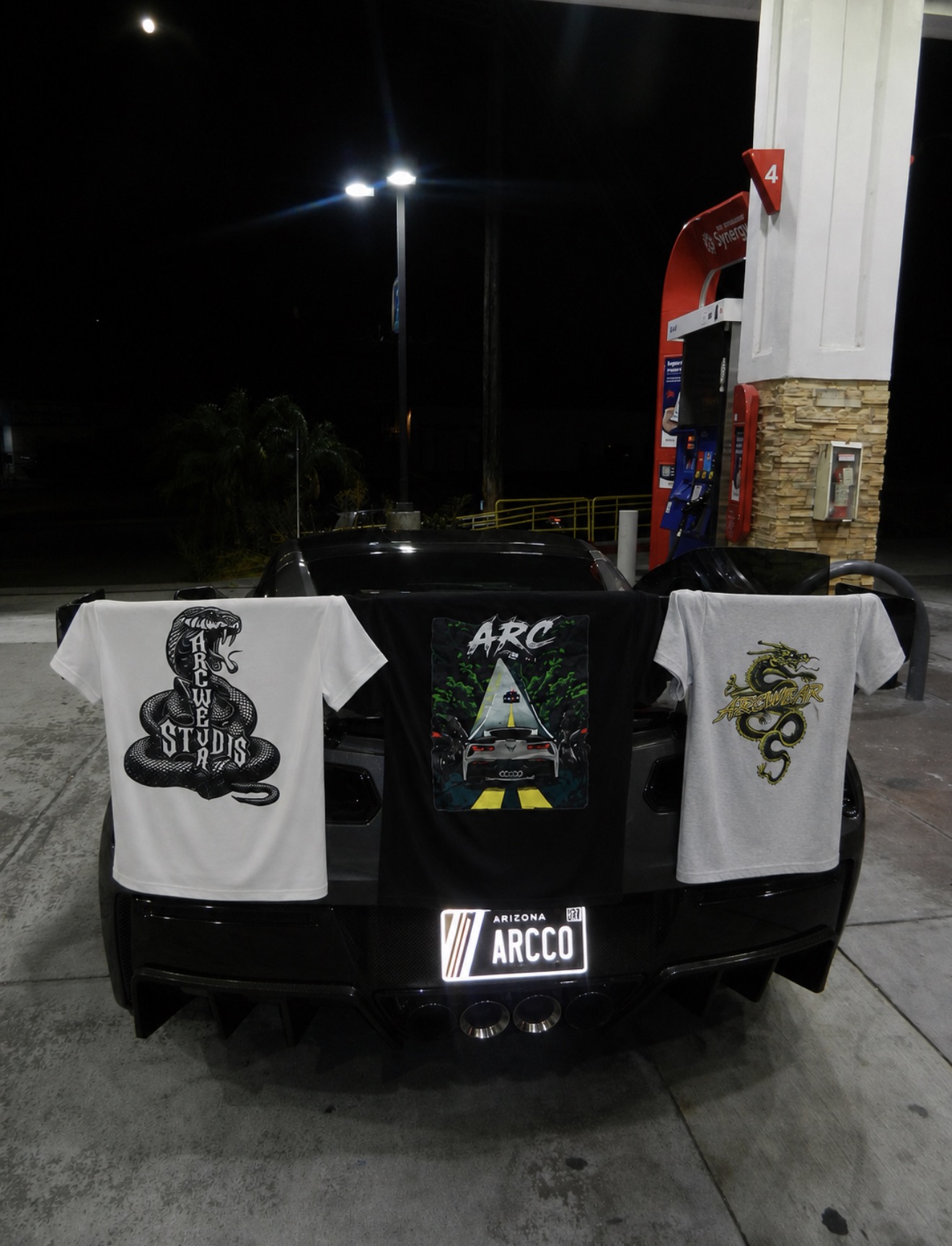 ARC tees displayed on a Corvette